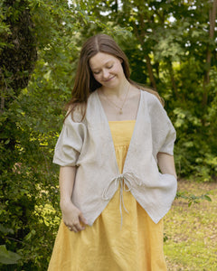 Model wears Lights of All's Sun wrap layered on top of the Anya Dress