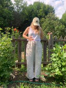 Linen pants and tank top worn with organic cotton baseball cap