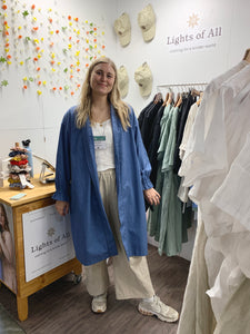 oversized denim jacket worn with beige linen pants