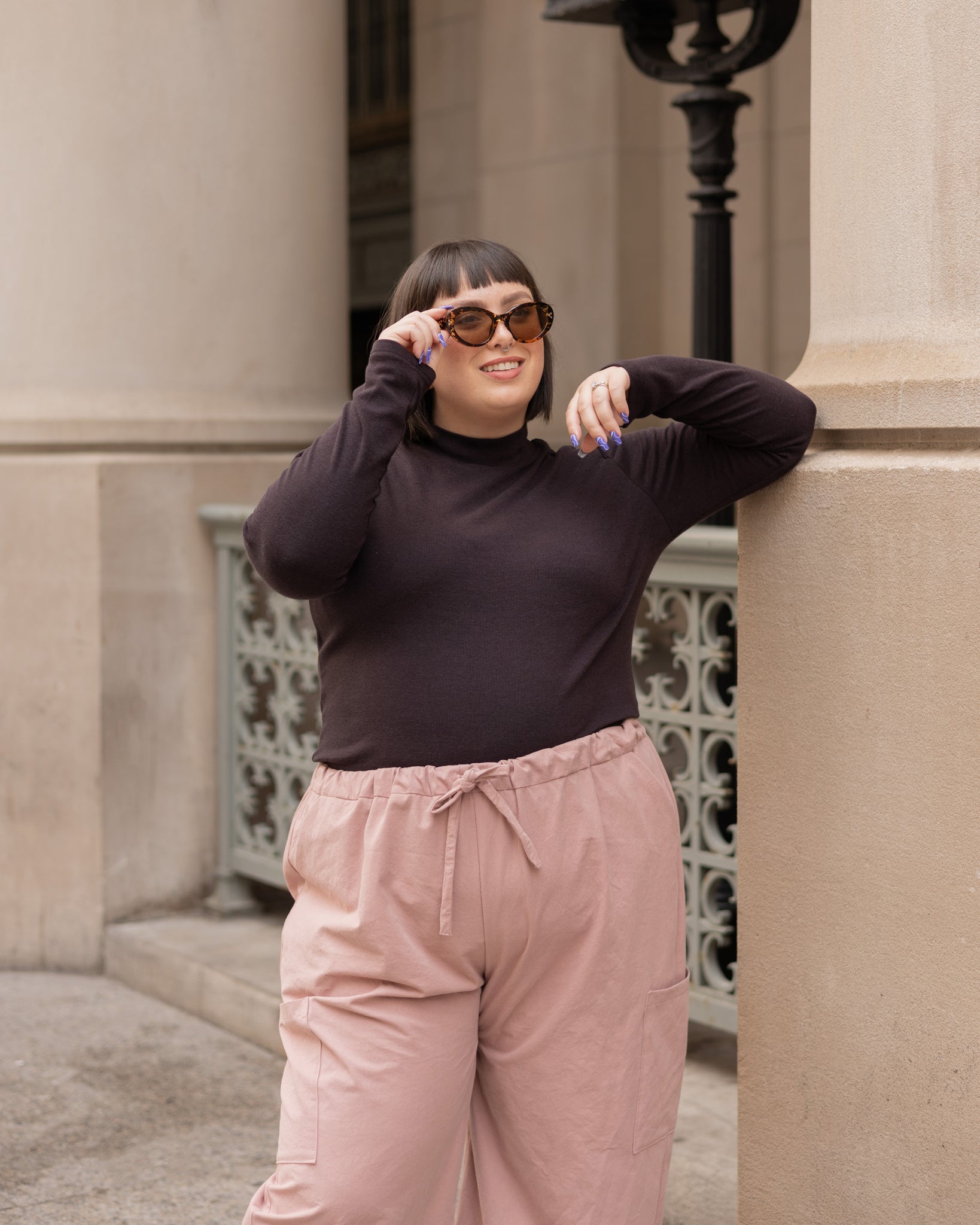 dark brown turtleneck and blush pink wide leg cargo pant