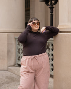 dark brown turtleneck and blush pink wide leg cargo pant