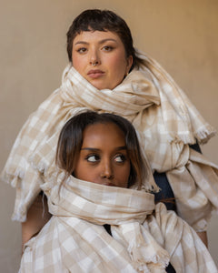 Two models wearing multiple organic cotton scarves 