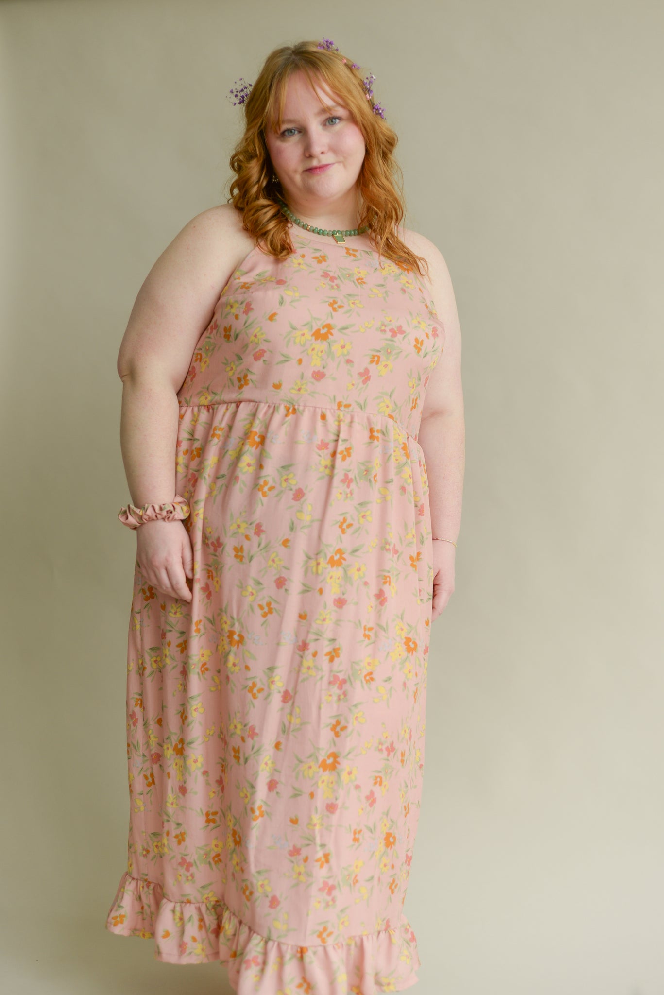 plus size model wearing a soft pink long tank top dress with a floral print