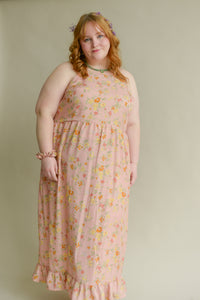 plus size model wearing a soft pink long tank top dress with a floral print